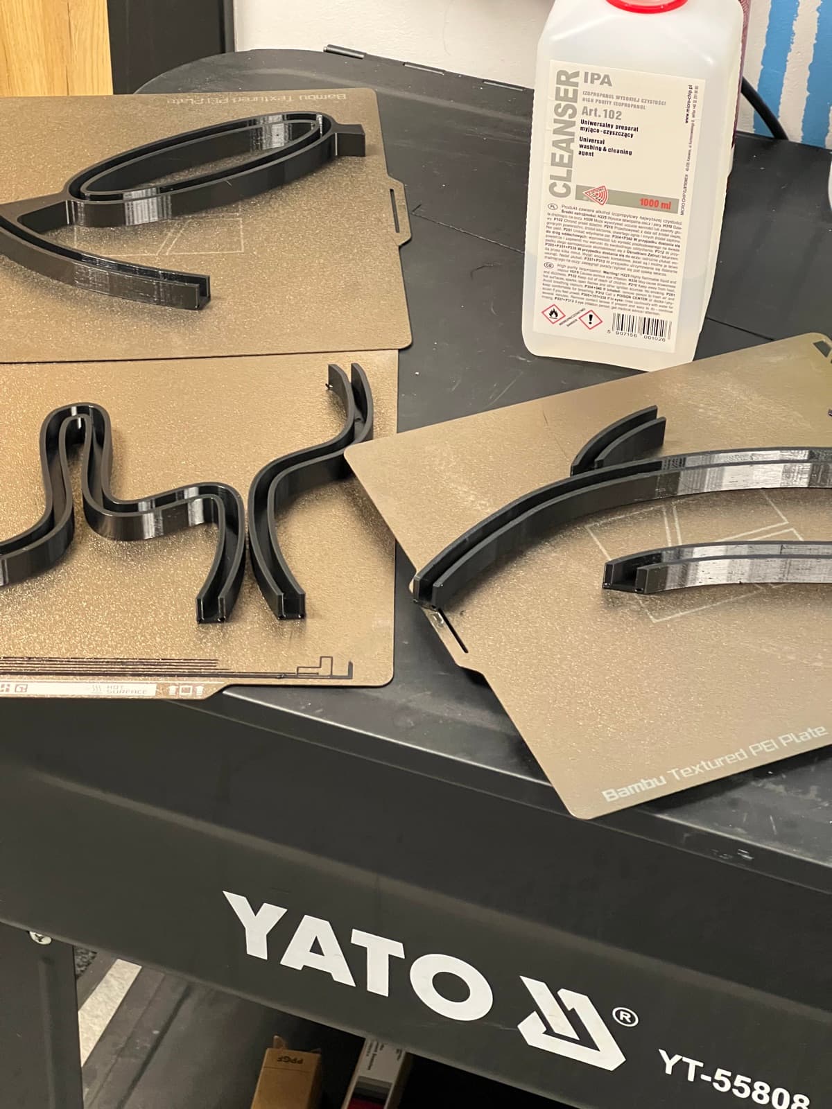 3D printed channel letters for the CORNER sign on Bambu build plates, on a workbench.