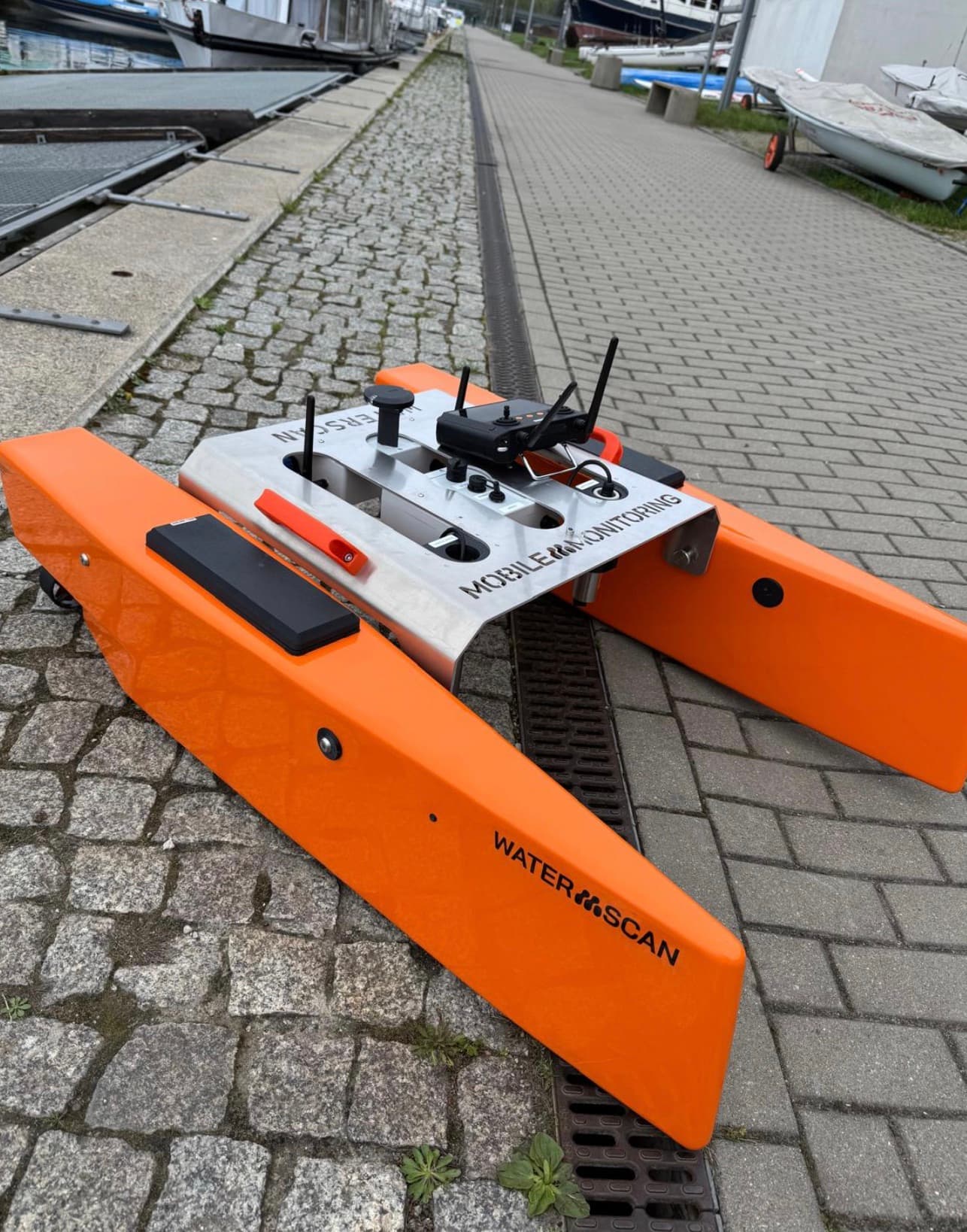 The WATER SCAN water drone on the quayside, with the electronics module and Mobile Monitoring branding visible.