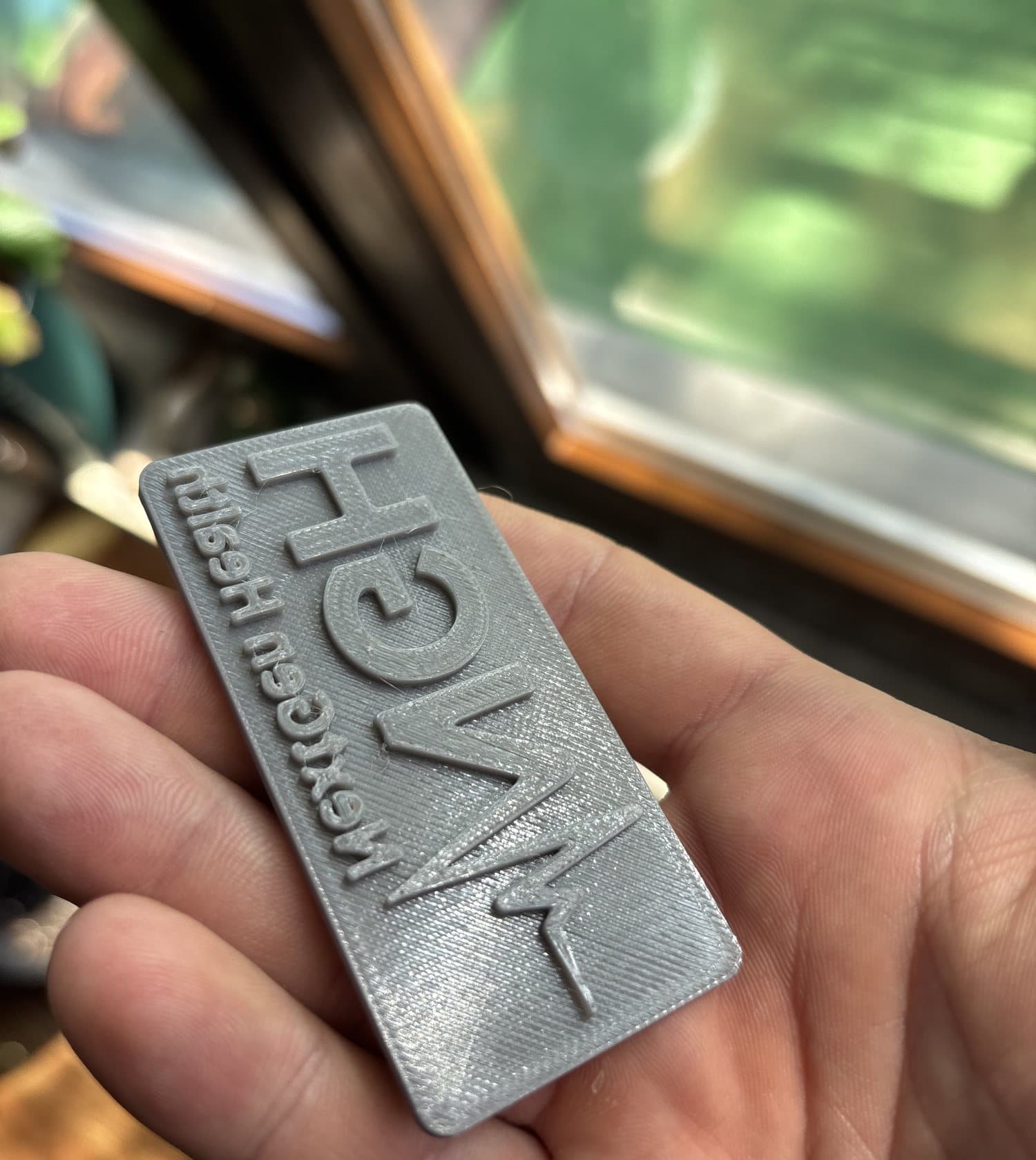 The printed stamp plate in hand: mirrored relief, straight walls, 0.1 mm layers.