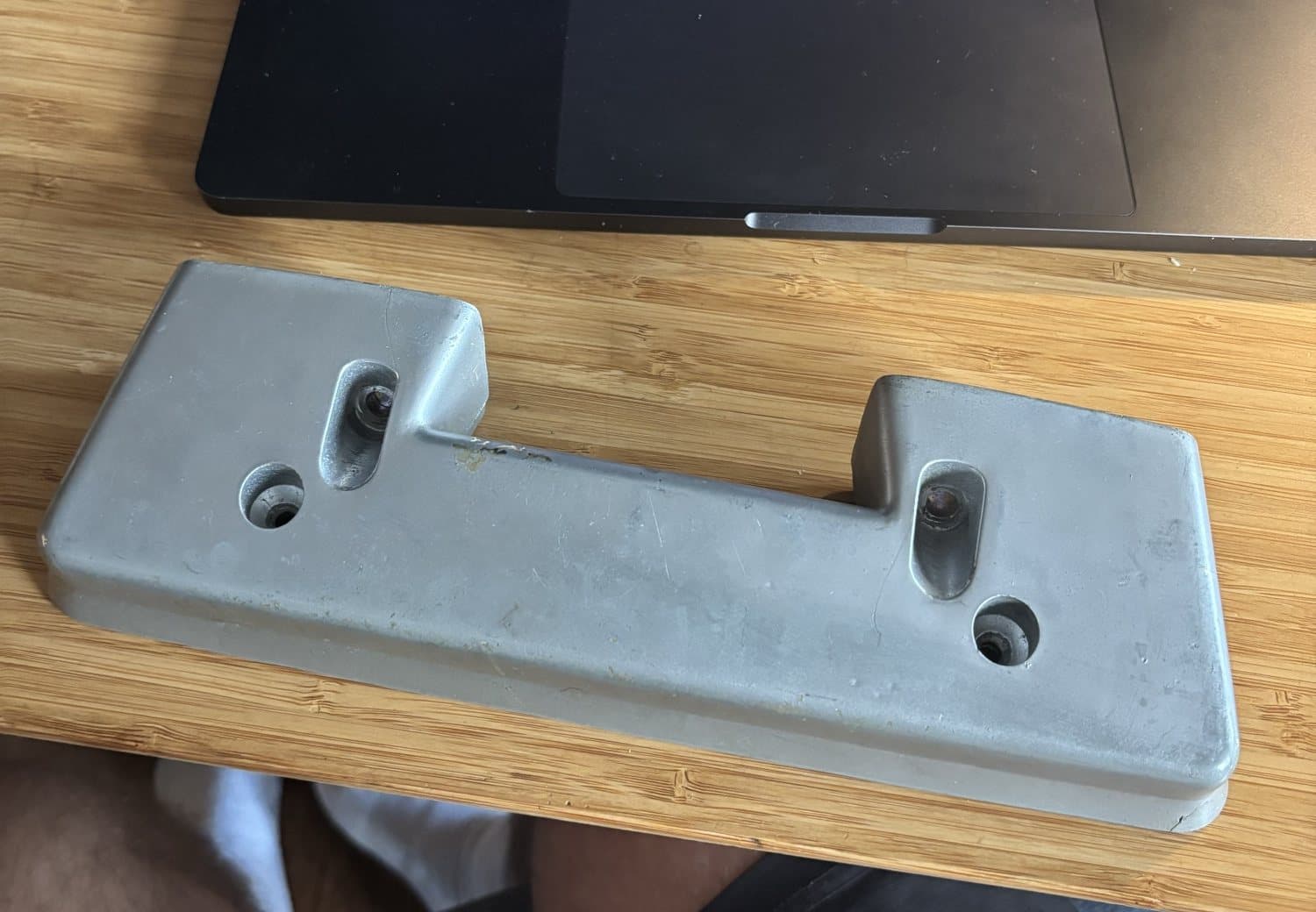 Face of the original: sloped surface, screw holes and head pockets.