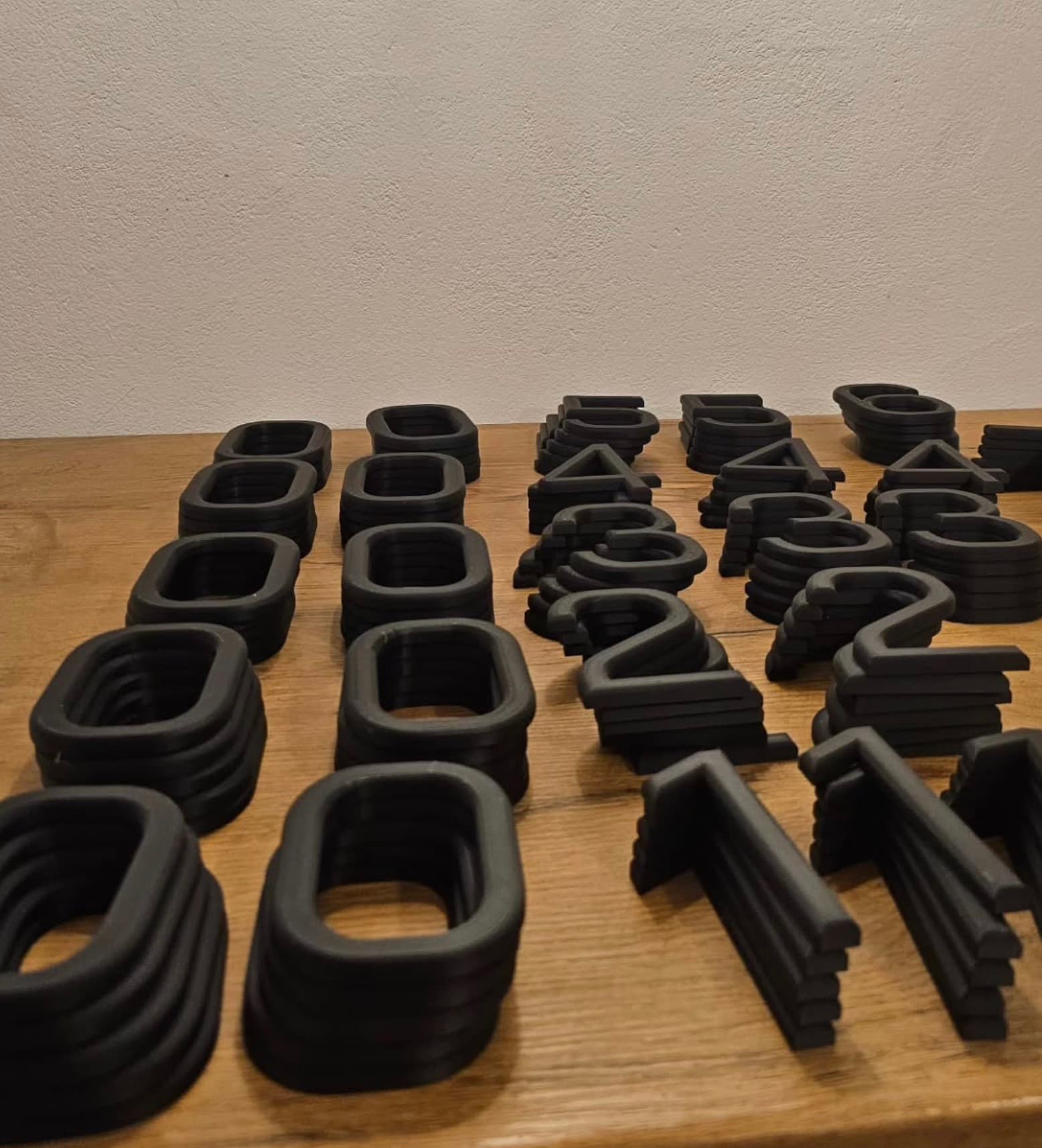 Full batch of printed digits sorted on the workbench before mounting