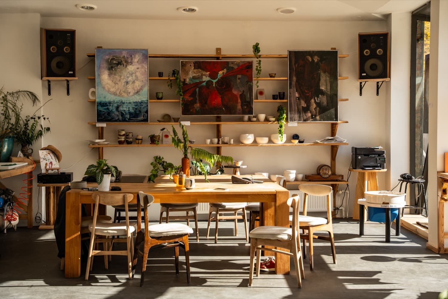 The Dom Sztuki Zar communal hall with art and ceramics on open shelves