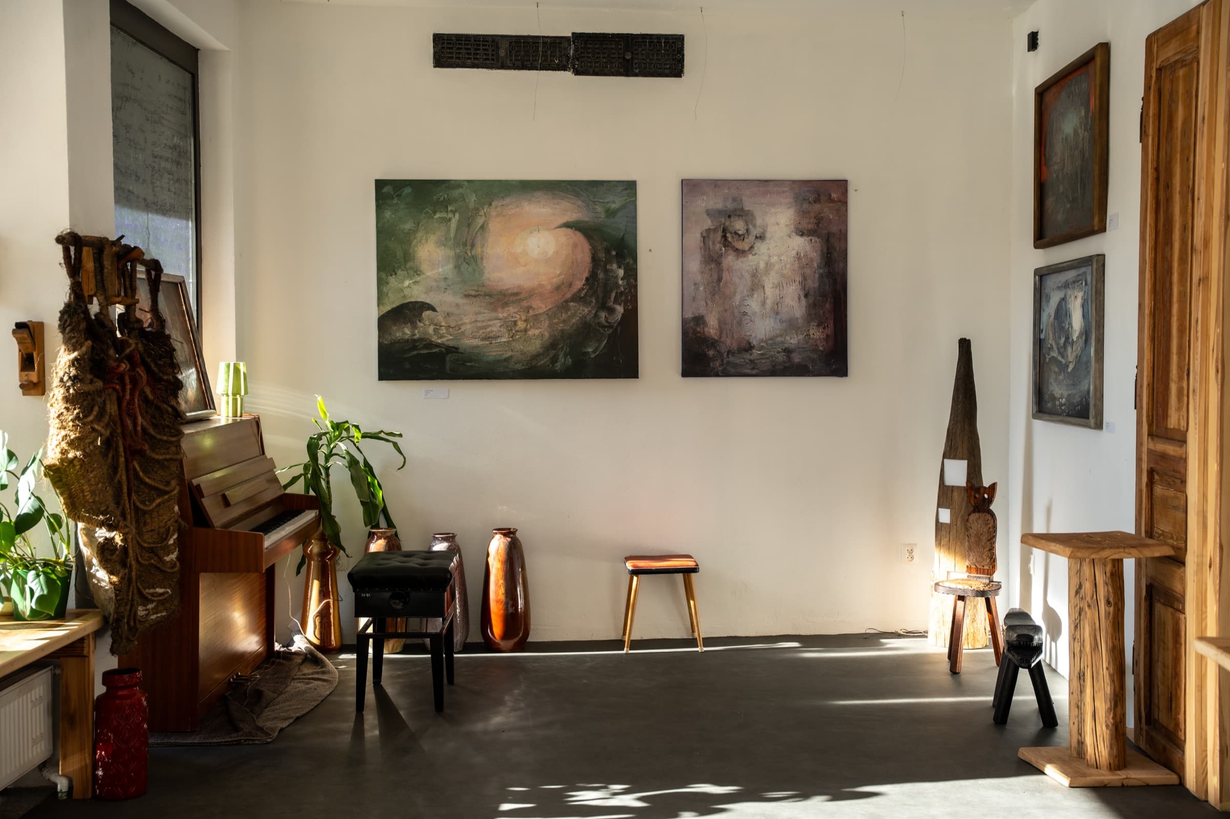 Gallery room at Dom Sztuki Zar with paintings and warm directional light